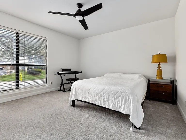 Bedroom with carpet and ceiling fan