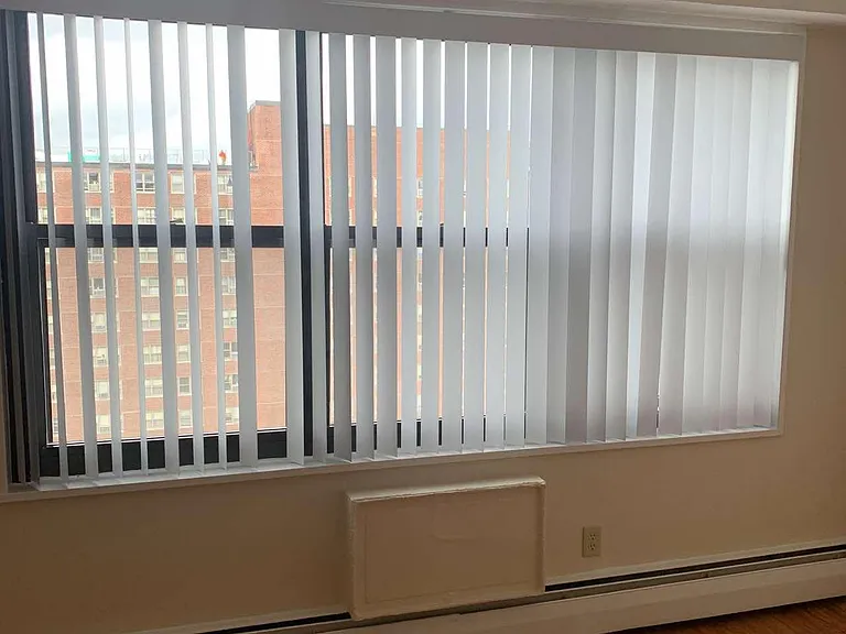 Large living room window with new vertical blinds