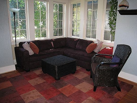 Living Room has fir floors, sunny corner windows & fireplace