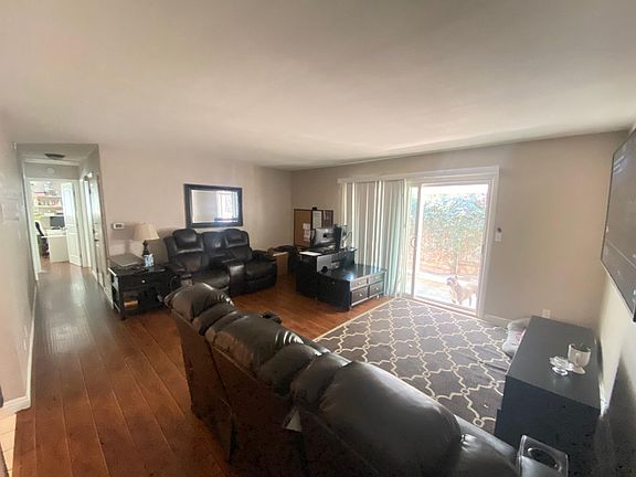 Living room from front door. Sliding glass door accesses wide patio yard.