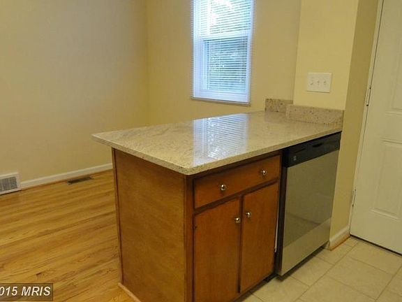 Island with Granite and Stainless Steel Dishwasher