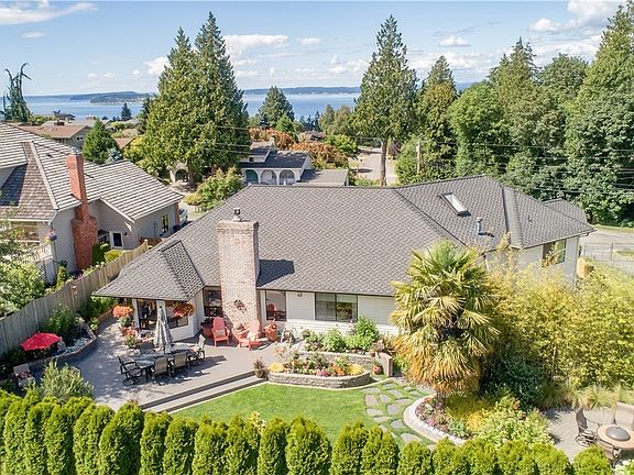 Aerial of the back yard oasis in spring time! Check out the private fire pit area!