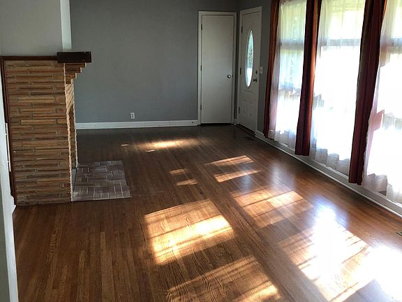 Living room/dining room with fireplace. New recess lighting has been added.