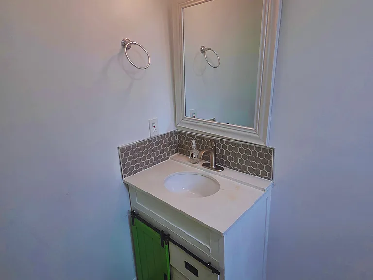 Beautiful illuminated vanity with cabinets and a large mirror