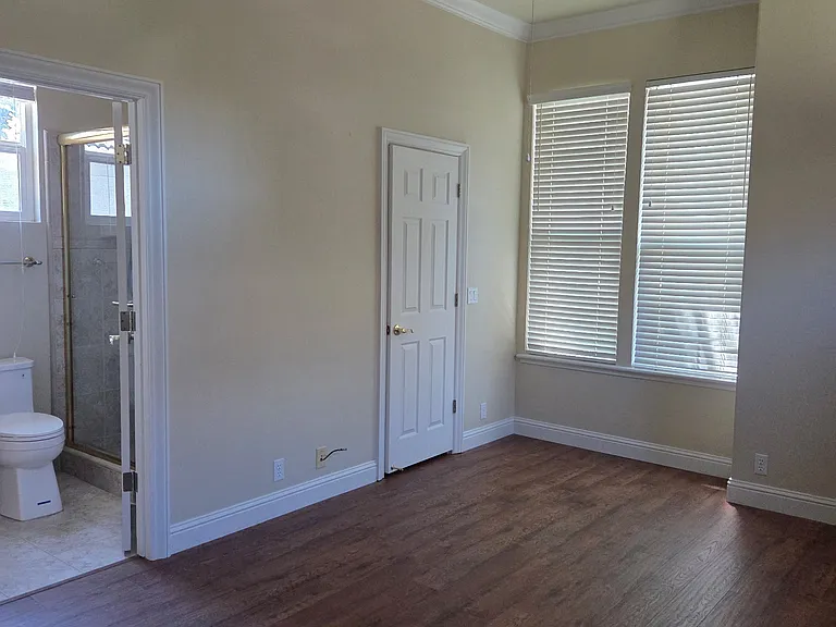 Bedroom on the other side of shared bathroom. Large walk-in closet, ceiling fan, light and bright