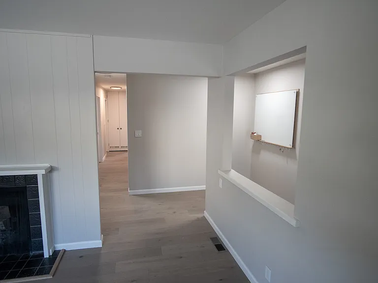 View down hallway to bedroom from living room