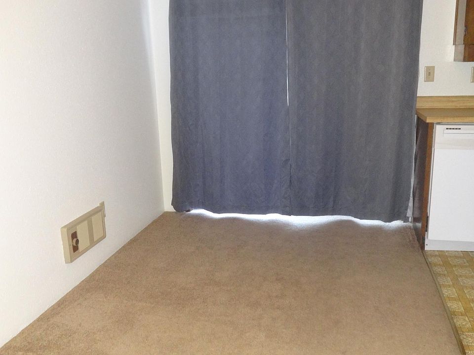 Dining room (view from the living room). Behind the curtains is the front private patio through the sliding patio door).