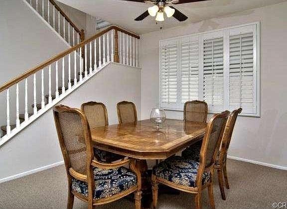 Large formal dining room with new ceiling fan  is open to living