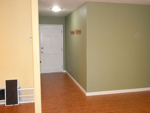 Entryway with solartube and wall coat-hangers.