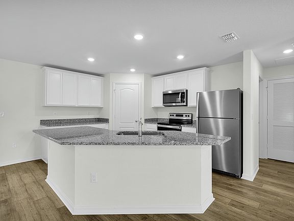 The kitchen has a large island that will be perfect for you and your family to gather around