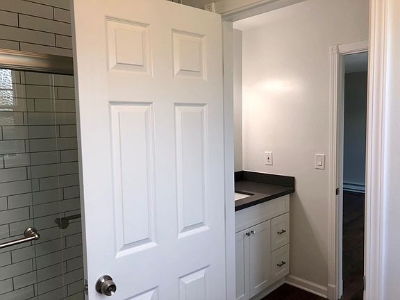 Master bedroom suite has a separate sink vanity adjoining room with tub/shower.