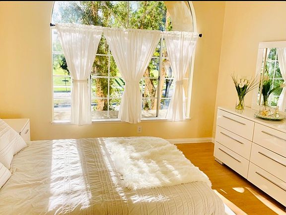 Second bedroom with access to the second bathroom, large window with view of the park