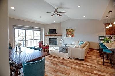 open floor plan with mountain views granite bar with seating large sliding glass doors with patio