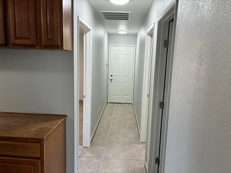 Facing garage door, bed and bath on sides.