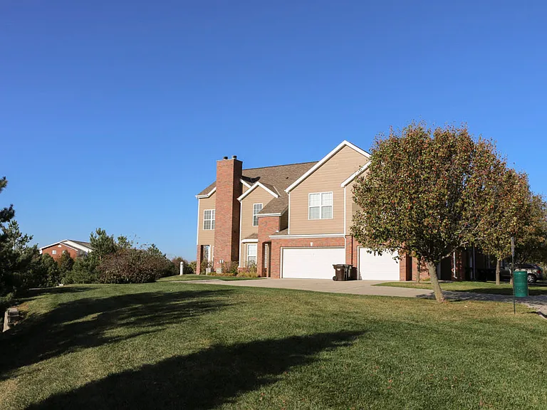 Enjoy the privacy of a neighborhood-style layout with attached garages, mature trees, and wide open green space.