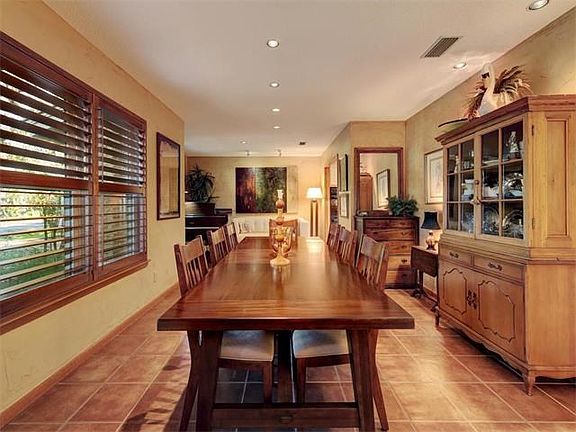 Formal dining with tile floors and wood shutters