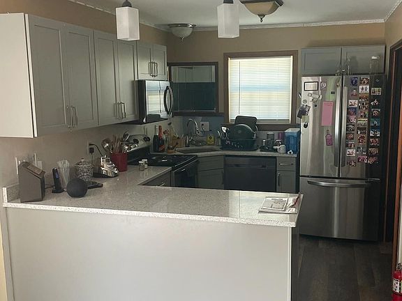 Newly remodeled kitchen and refrigerator. Open to breakfast area with counter.