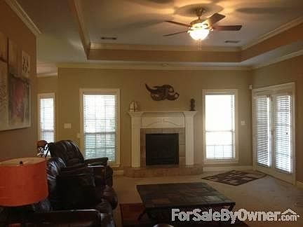 Living Room
						:
						Tray ceiling, crown molding and gas log fireplace adorn the living area!