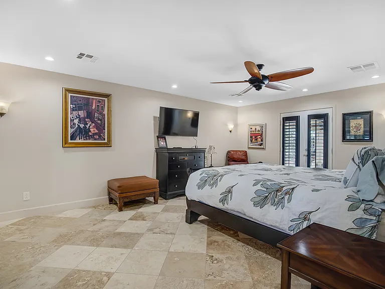 Private bedroom with ensuite bath with access to driveway and courtyard.