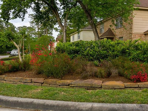 Stone-lined flower beds, fresh mulch, green grass and full canopy trees. From the moment you pull up... the oohs and ahhs will begin!