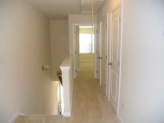 landing upstairs |hallway between two suits. houses laundry |linen closet |2nd AC thermostat| attic above