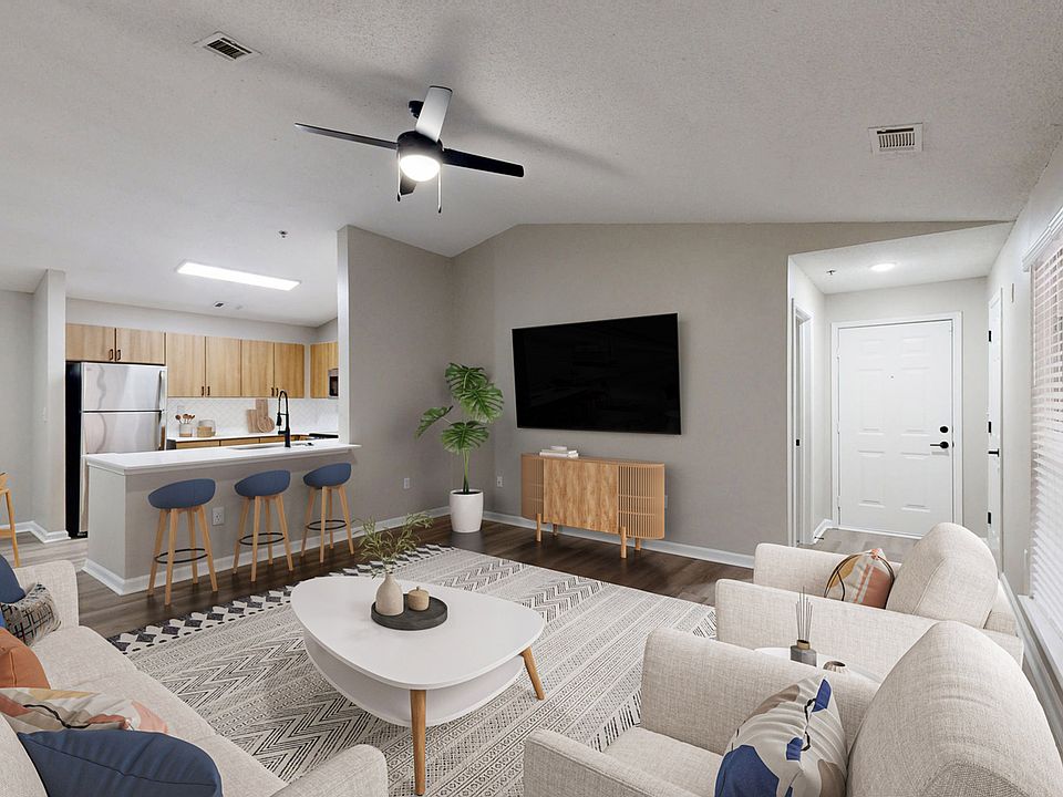 Open floorplan kitchen/living room with modern hardwood style flooring.