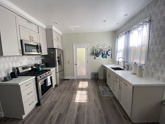 Large kitchen with stainless appliances.