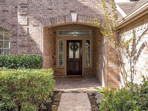 Covered front porch and lovely wood front door make a great first impression.