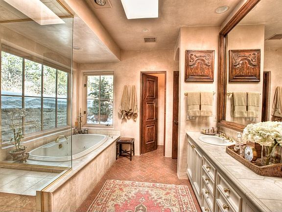 Swaths of cool limestone contribute to an overall sense of elegance & indulgence in this impressive 