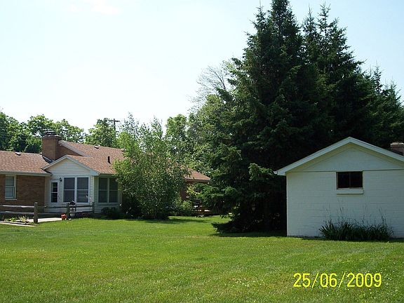 NW rear w/ storage shed