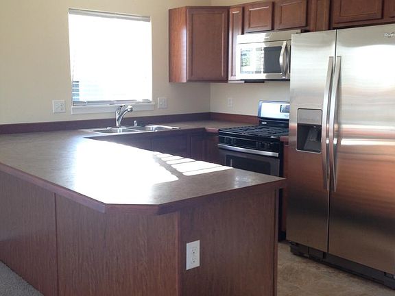 Beautiful open kitchen with stainless steal appliances.