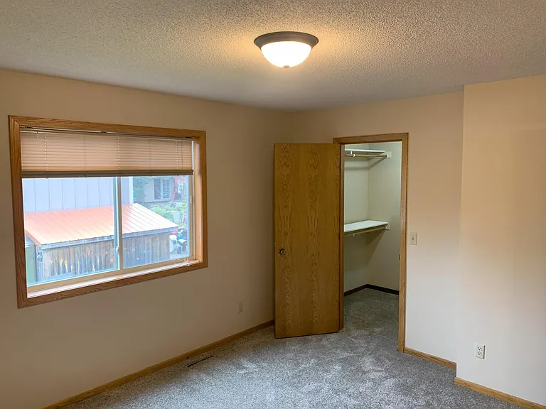 Primary bedroom on upper level features walk-in closet and direct access to full bathroom.