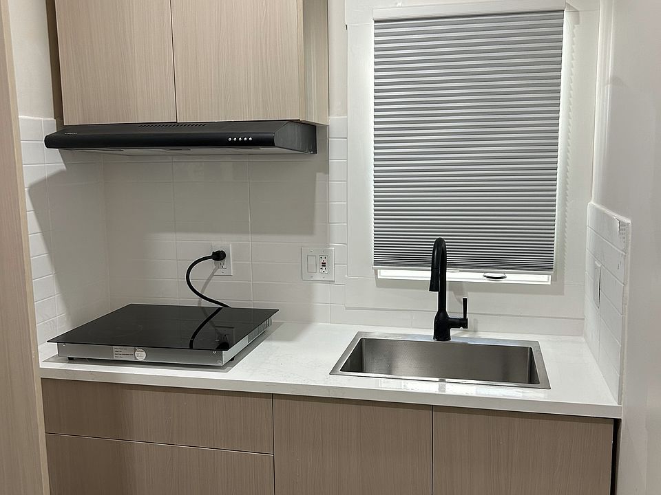 Efficiency kitchen space with fridge. Wall to the right can accommodate a small eating/office space table.