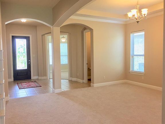 The tile entrance with the office to the right. The spacious office offers french doors and a half bath close by.