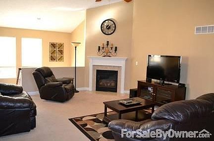 Living room with vaulted ceiling
						:
						Living room has lots of space, gas fireplace, vaulted ceiling, and large windows