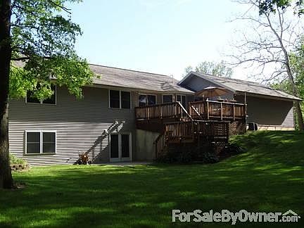Back view showing full walkout basement
						:
						Fully open back with walkout and wrapping staircase from the deck to back patio.