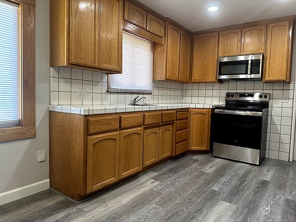 Kitchen with can lighting new stove, micro and refrigerator