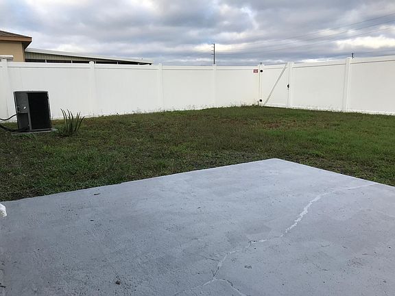Gate at the corner leads to a big grass field and playground