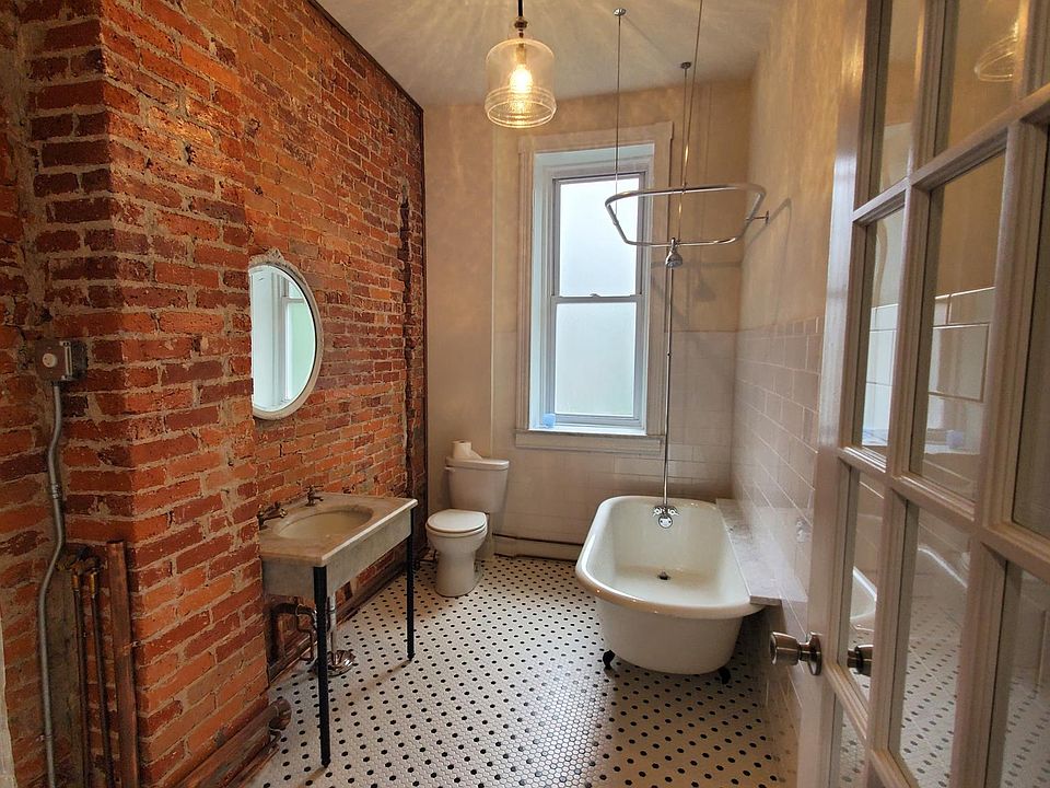 Stunning bathroom with original Victorian era sink and claw foot tub.