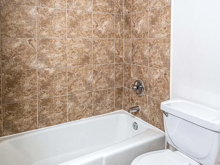 Updated bathrooms with tiled bathroom shower and tub, cherry maple vanity and premier lighting