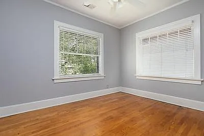 Bedroom #2 with closet, ceiling fan and 2 original wall sconce lights. Window box planter outside front window.