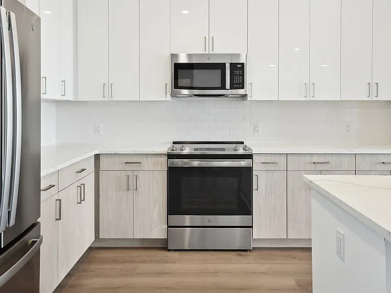 Kitchen with Stainless Steel Appliances and White Granite Countertops