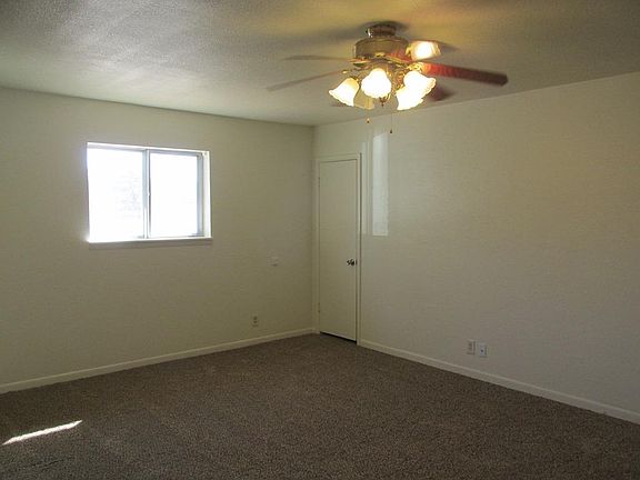 LIVING ROOM LOOKING AT FRONT WINDOW AND CLOSET DOOR