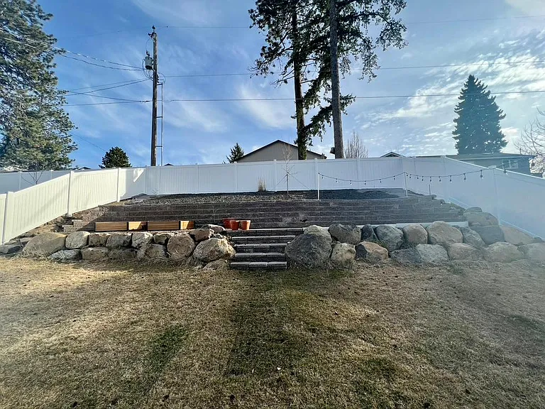 Landscaped backyard with planter boxes (left) and seating area (right).