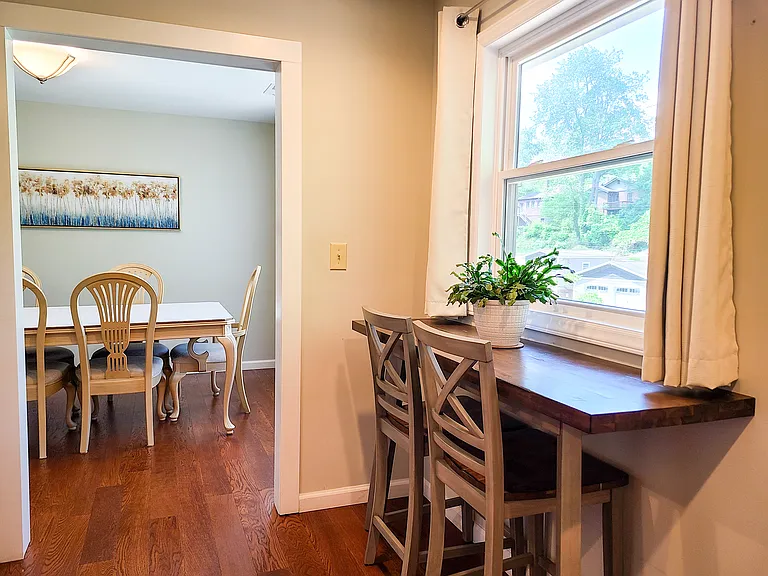 Breakfast bar and view to the dining room. The home has large, beautiful windows, letting in lots of natural light.