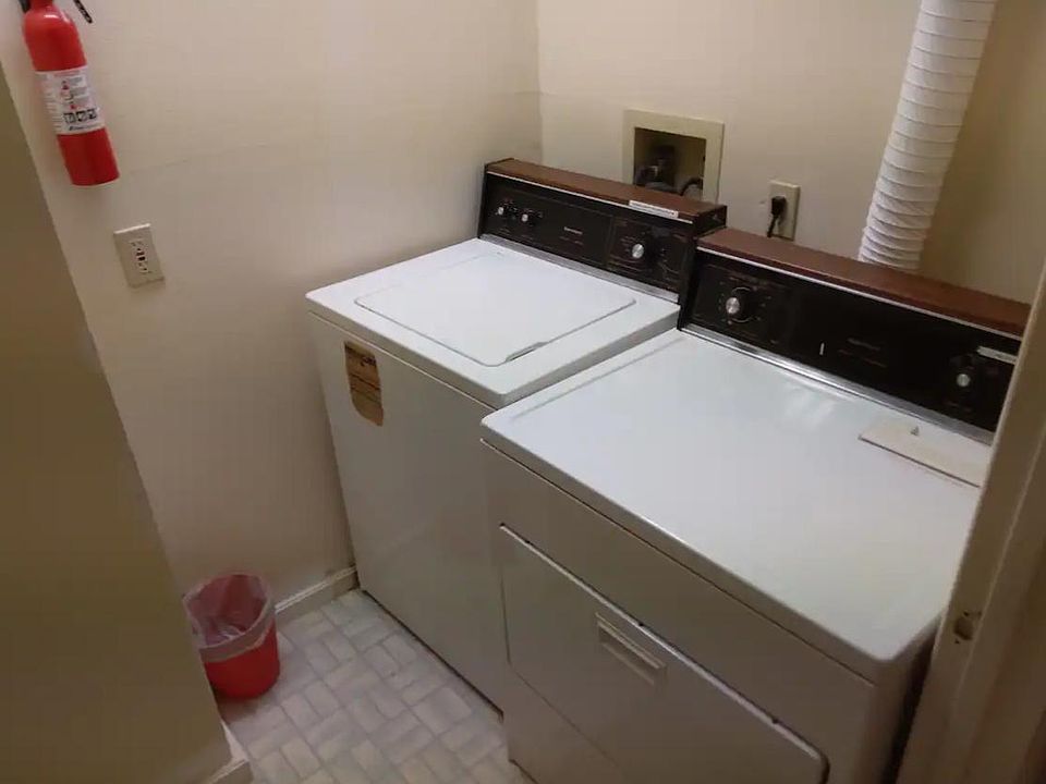private laundry room with washer/dryer, and iron and ironing board (not shown)