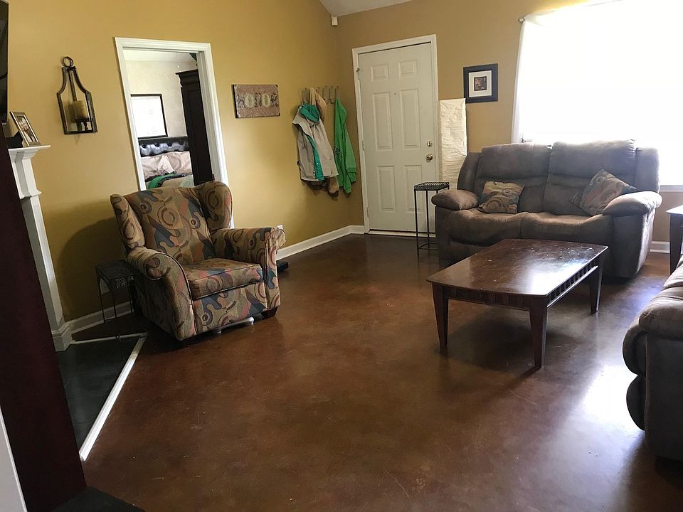 Great cathedral living room with stained concrete floors and