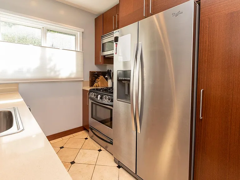 Kitchen with stone counter and stainless steel appliances and gas stove/over