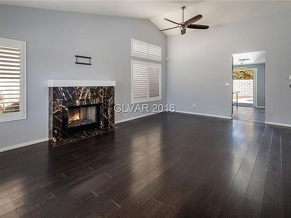LIVING/DINING COMBO BOAST HIGH VAULTED CEILING & BEAUTIFUL CUSTOM MARBLE FIREPLACE.