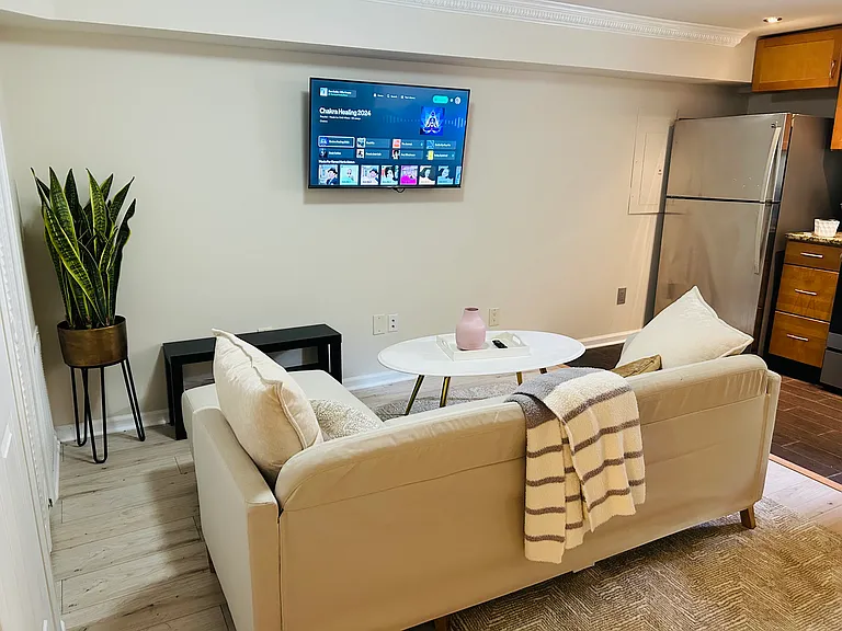Living room with smart TV, seating and ambience
